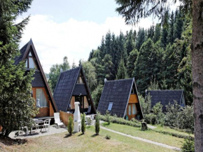 Wooden chalet with terrace near a swimming lake